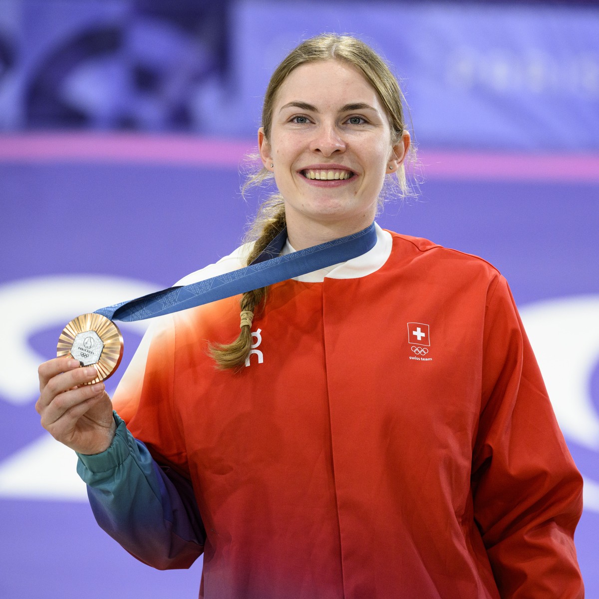 Bronze medalist Zoe Claessens of Switzerland celebrates with her medal during the medal ceremony after the women's cycling BMX final race at the 2024 Paris Summer Olympics in Paris, France, Frida ...