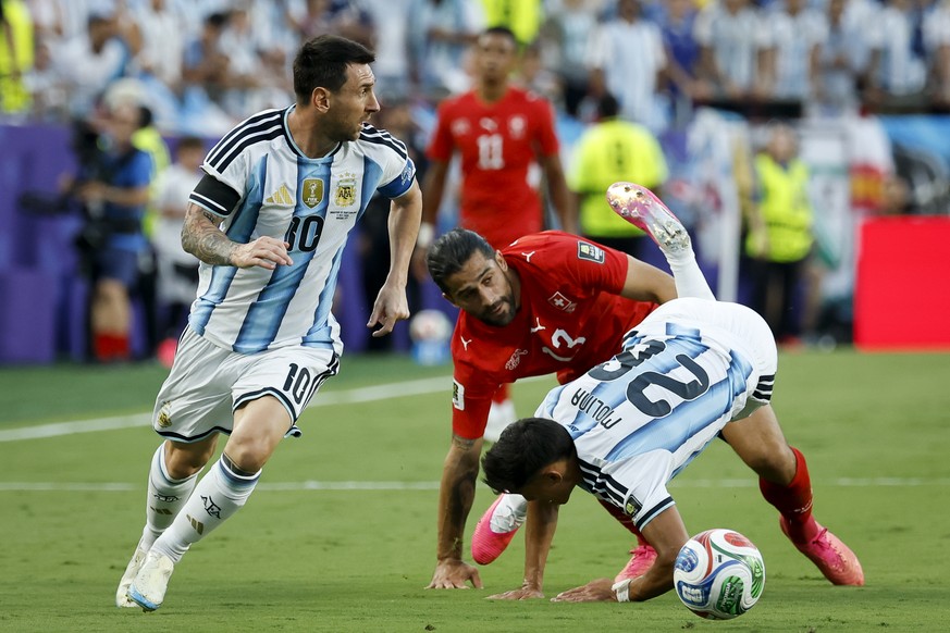 From left: Argentina's Lionel Messi, Switzerland's Ricardo Rodriguez and Argentina's Nahuel Molina fight for the ball during the World Cup quarter final match between Argentina and Swit ...