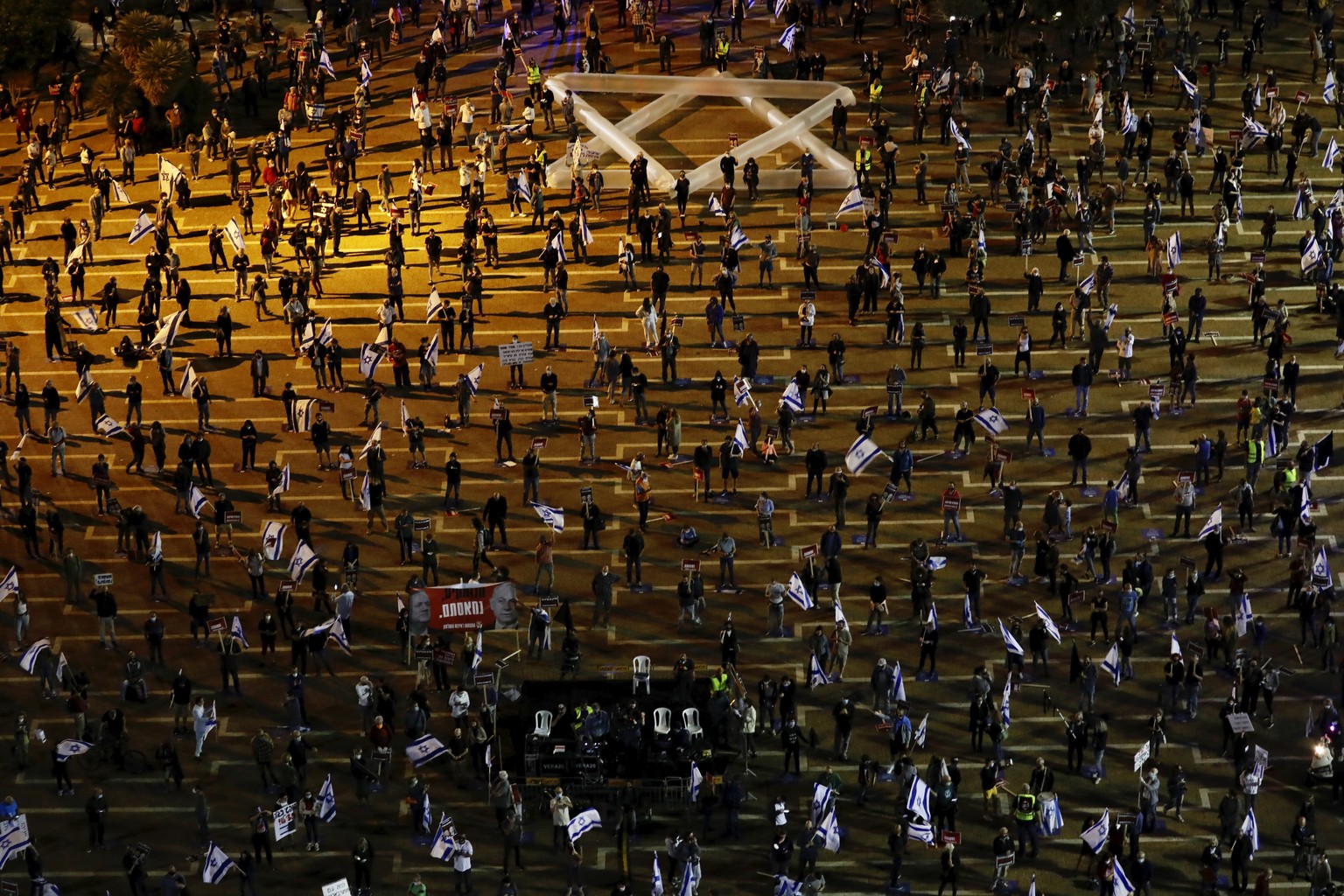 People keep social distance amid concerns over the country&#039;s coronavirus outbreak, during a protest against Prime Minister Benjamin Netanyahu and Benny Gantz and government corruption, at Rabin s ...