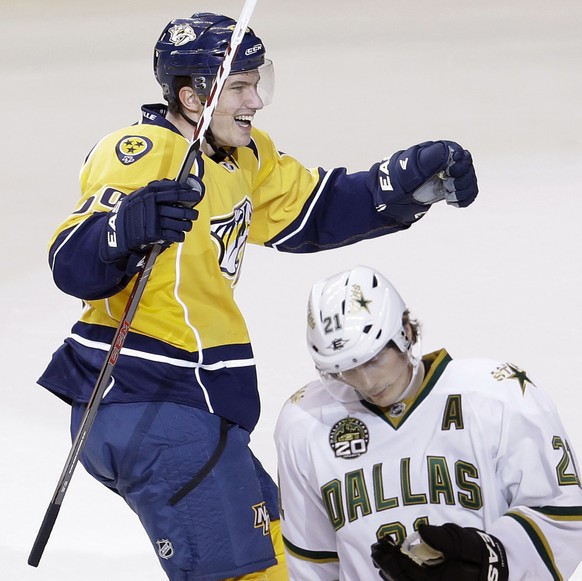 Nashville Predators defenseman Roman Josi, of Switzerland, top, celebrates and Dallas Stars left wing Loui Eriksson (21), of Sweden, skates off the ice after Josi scored the winning goal in overtime i ...