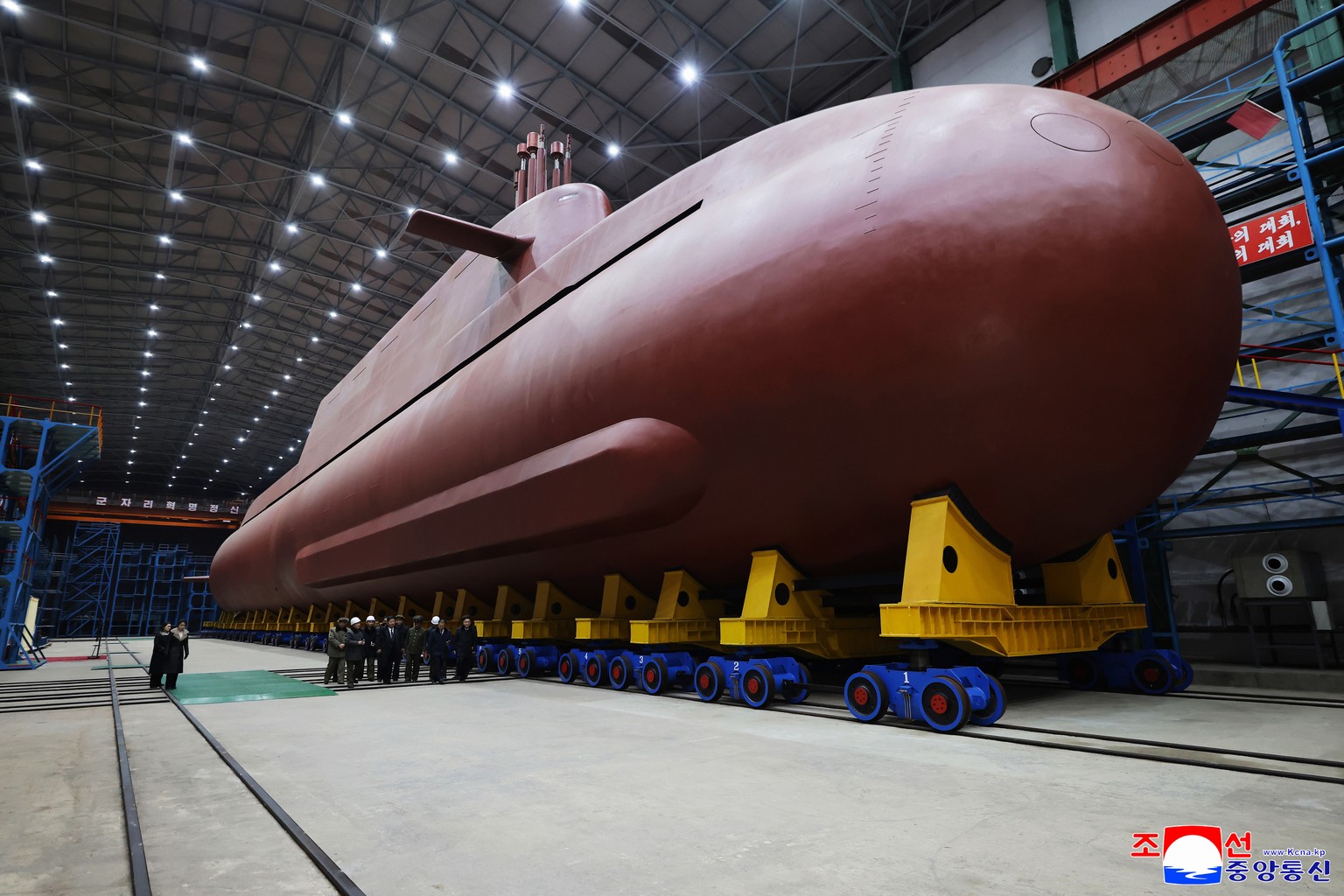 In this undated photo provided Thursday, Dec. 25, 2025, by the North Korean government, its leader Kim Jong Un inspects a nuclear-powered submarine under construction at an undisclosed location in Nor ...