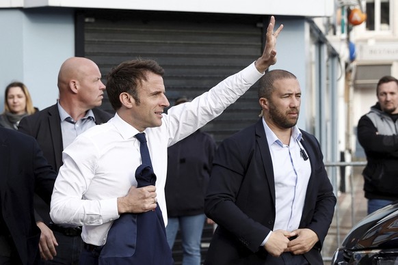 Current French President and centrist presidential candidate for reelection Emmanuel Macron waves to supporters during a visit in Carvin, northern France, Monday, April 11, 2022 . French President Emm ...