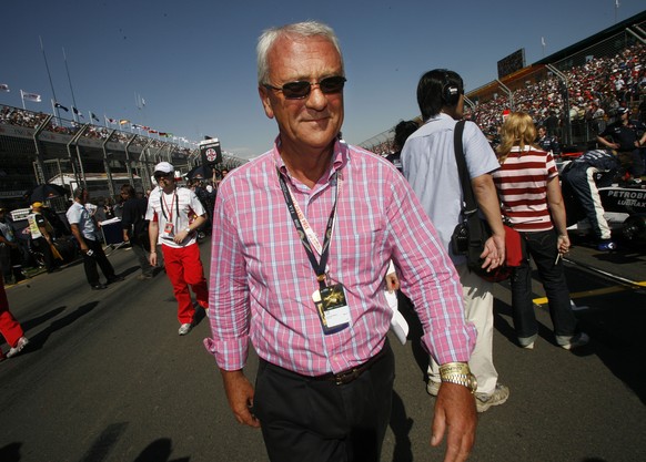 Red Bull and Toro Rosso team owner and founder of the energy drink brand Red Bull, Dietrich Mateschitz, walks the grid prior to the start of the season-opening Australian Grand Prix auto race in Melbo ...