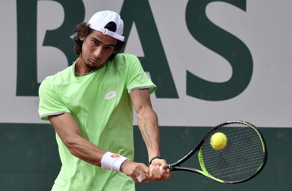 epa07612846 Lloyd Harris of South Africa plays Borna Coric of Croatia during their men’s second round match during the French Open tennis tournament at Roland Garros in Paris, France, 30 May 2019. EPA ...