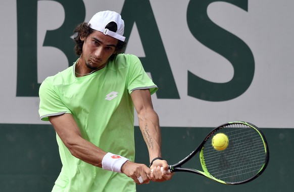 epa07612846 Lloyd Harris of South Africa plays Borna Coric of Croatia during their menâs second round match during the French Open tennis tournament at Roland Garros in Paris, France, 30 May 2019. E ...