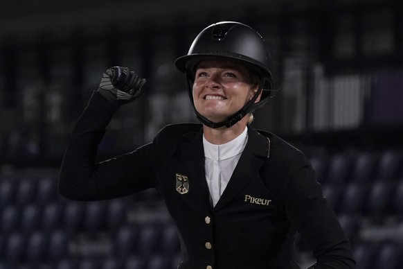 Germany&#039;s Julia Krajewski, riding Amande de B&#039;Neville, celebrates after winning the equestrian eventing jumping individual final at Equestrian Park in Tokyo at the 2020 Summer Olympics, Mond ...