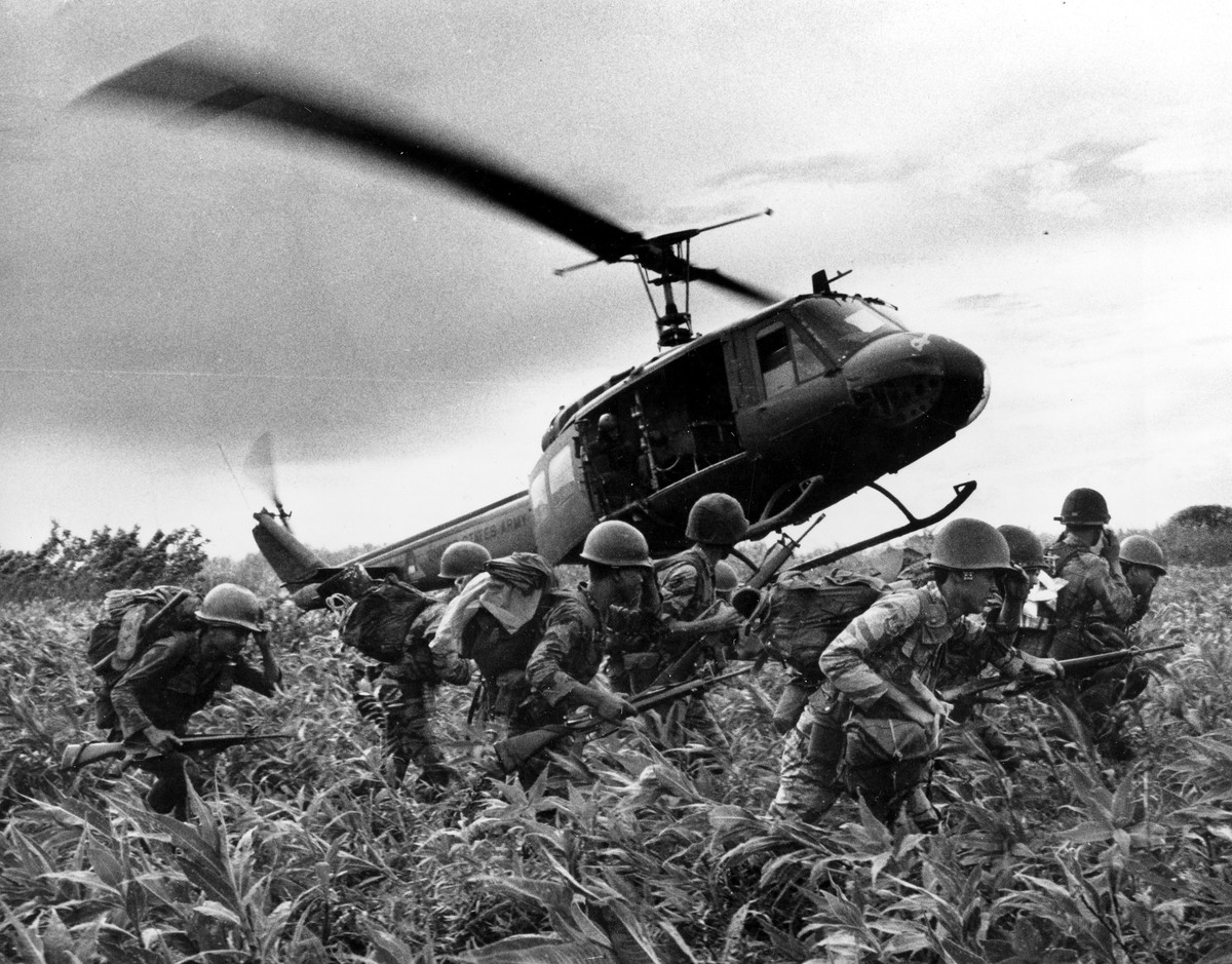 FILE- In this June 1970 file photo, taken by Associated Press photographer Huynh Cong "Nick" Ut, south Vietnamese Marines rush to the point where descending U.S. Army helicopter will pick th ...