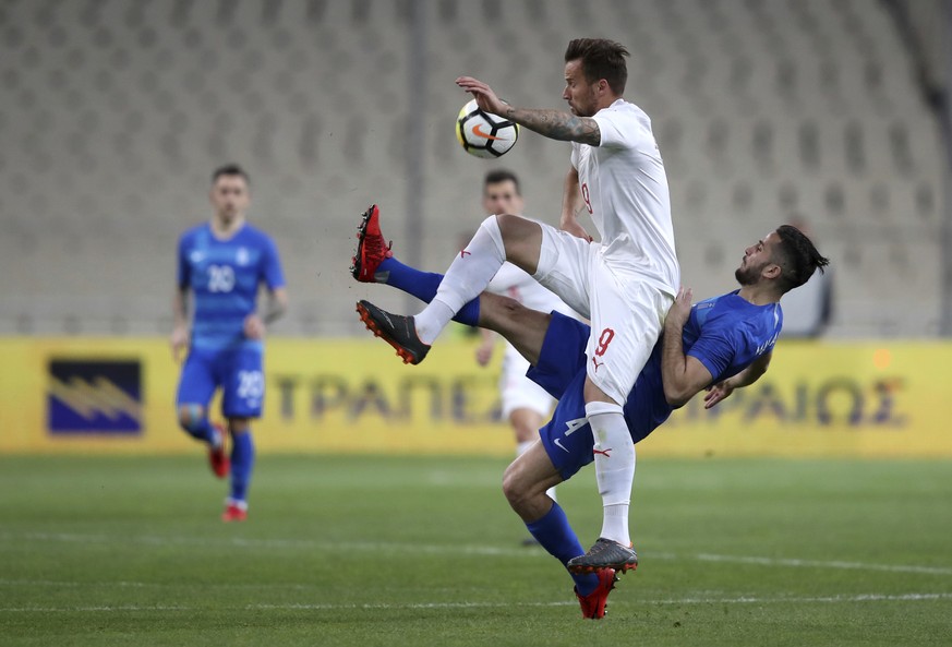 Switzerland&#039;s Haris Seferovic, front, duels for the ball with Greece&#039;s Kostas Manolas during an international friendly soccer match between Greece and Switzerland at the Olympic stadium in A ...