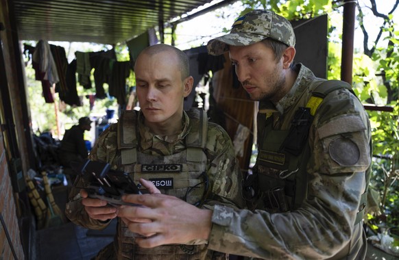 FILE - Ukrainian servicemen correcting artillery fire by drone at the frontline near Kharkiv, Ukraine, on Saturday, July 2, 2022. Never in the history of warfare have drones been used as intensively a ...