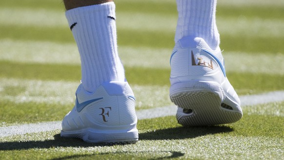 Roger Federer of Switzerland wears Nike shoes with his logo during a training session at the All England Lawn Tennis Championships in Wimbledon, London, Wednesday, June 27, 2018. The Wimbledon Tennis  ...
