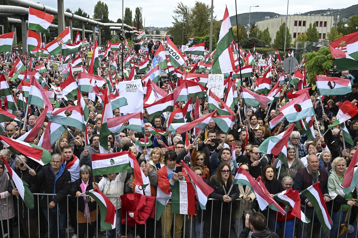 Participants wave national flags during a demonstration organised by the Hungarian opposition Tisza Party against public media at the MTVA headquarters in Budapest, Hungary, Saturday, Oct. 5, 2024. (S ...