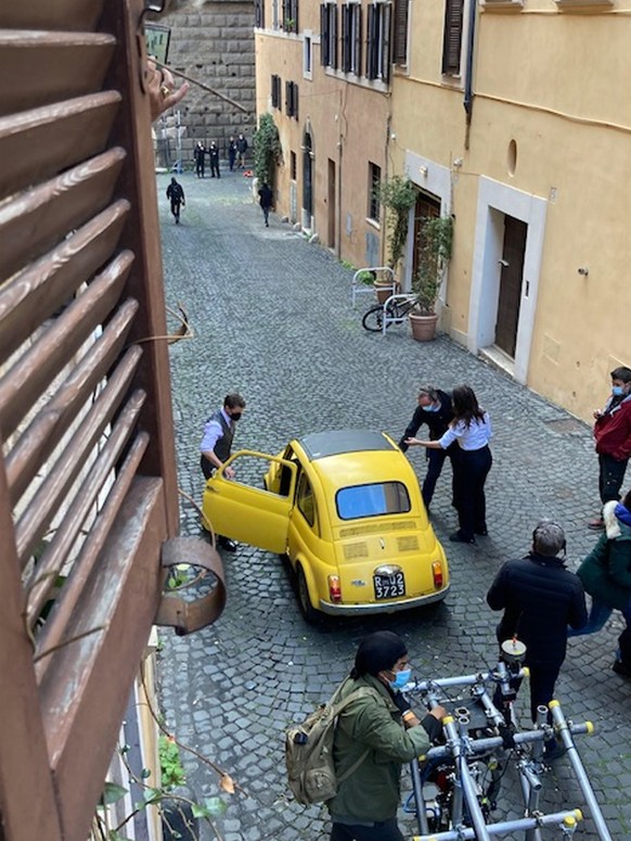 epa08841259 US actor Tom Cruise stands next to a yellow vintage car during the filming of the movie &#039;Mission: Impossible - Lybra&#039; at the Monti district in Rome, Italy, 25 November 2020. The  ...