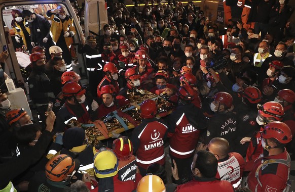 In this photo provided by the government&#039;s Search and Rescue agency AFAD, rescue workers, who were trying to reach survivors in the rubble of a collapsed building, carry to an ambulance 14-year-o ...