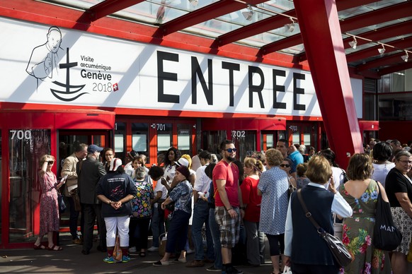 Pilgrims wait at the entrance for Holy Mass of Pope Francis, at the Palexpo hall, in Geneva, Switzerland, Thursday, June 21, 2018. Pope Francis visit the World Council of Churches on 21 June as centre ...