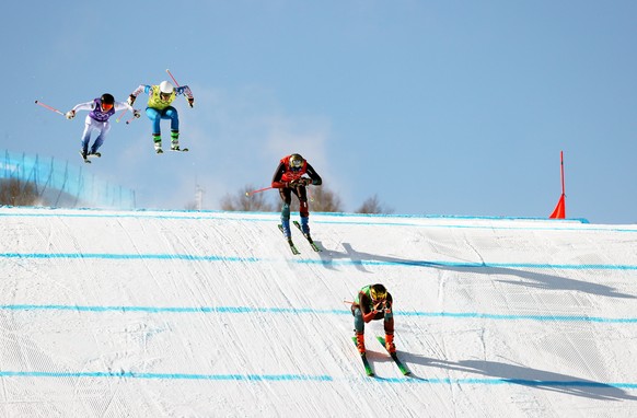 epa09768307 (L-R) Erik Mobaerg of Sweden, Sergey Ridzik of Russia, Alex Fiva of Switzerland and Ryan Regez of Switzerland in action during the Men&#039;s Freestyle Skiing Ski Cross big final at the Zh ...