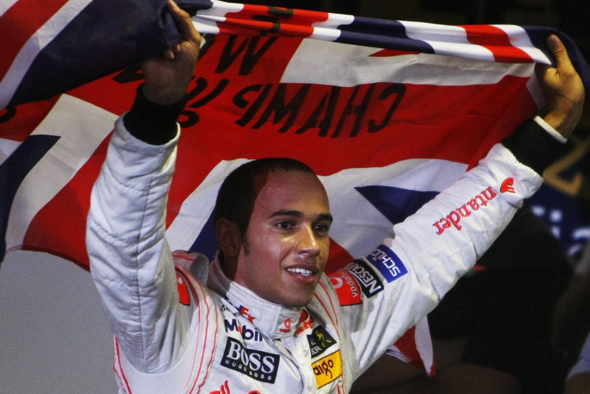 ** FILE ** This Nov. 2, 2008, file photo shows McLaren-Mercedes' Formula One driver Lewis Hamilton, of Britain, celebrating after he secured the 2008 Formula One world drivers' championship  ...