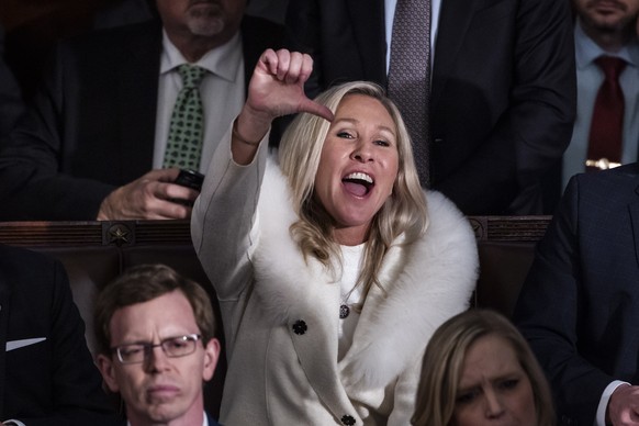 epa10453796 Republican Representative from Georgia Marjorie Taylor Greene reacts as US President Joe Biden delivers his State of the Union address before a joint session of Congress in the United Stat ...