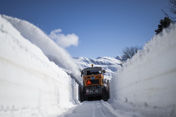 epa11299597 A snow truck clears the road at the San Bernardino Pass in Spluegen, Switzerland, 25 April 2024. The winter of 2024 was very snowy for the canton of Graubunden, but not yet record-breaking ...