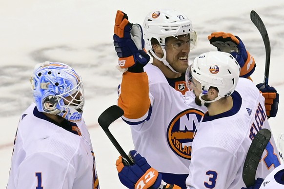 New York Islanders left wing Anders Lee (27), defenseman Adam Pelech (3) and goaltender Thomas Greiss (1) celebrate after defeating the Philadelphia Flyers after third-period NHL Stanley Cup Eastern C ...