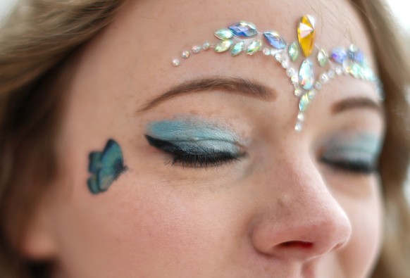 epa11407902 A Taylor Swift fan wears eye makeup and face decorations in Liverpool, Britain, 13 June 2024. Taylor Swift will play three nights at Liverpool FC?s Anfield stadium from 13 to 15 June 2024 ...
