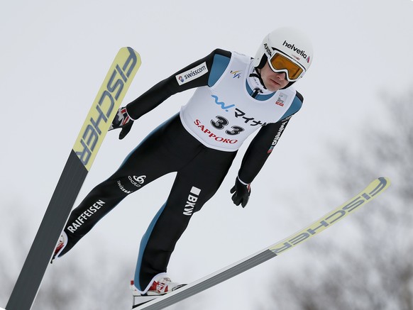 epa05786764 Simon Ammann of Switzerland soars during the first jump of the 22nd FIS World Cup ski jumping large hill individual competition in Sapporo, northern Japan, 12 February 2017. EPA/KIMIMASA M ...