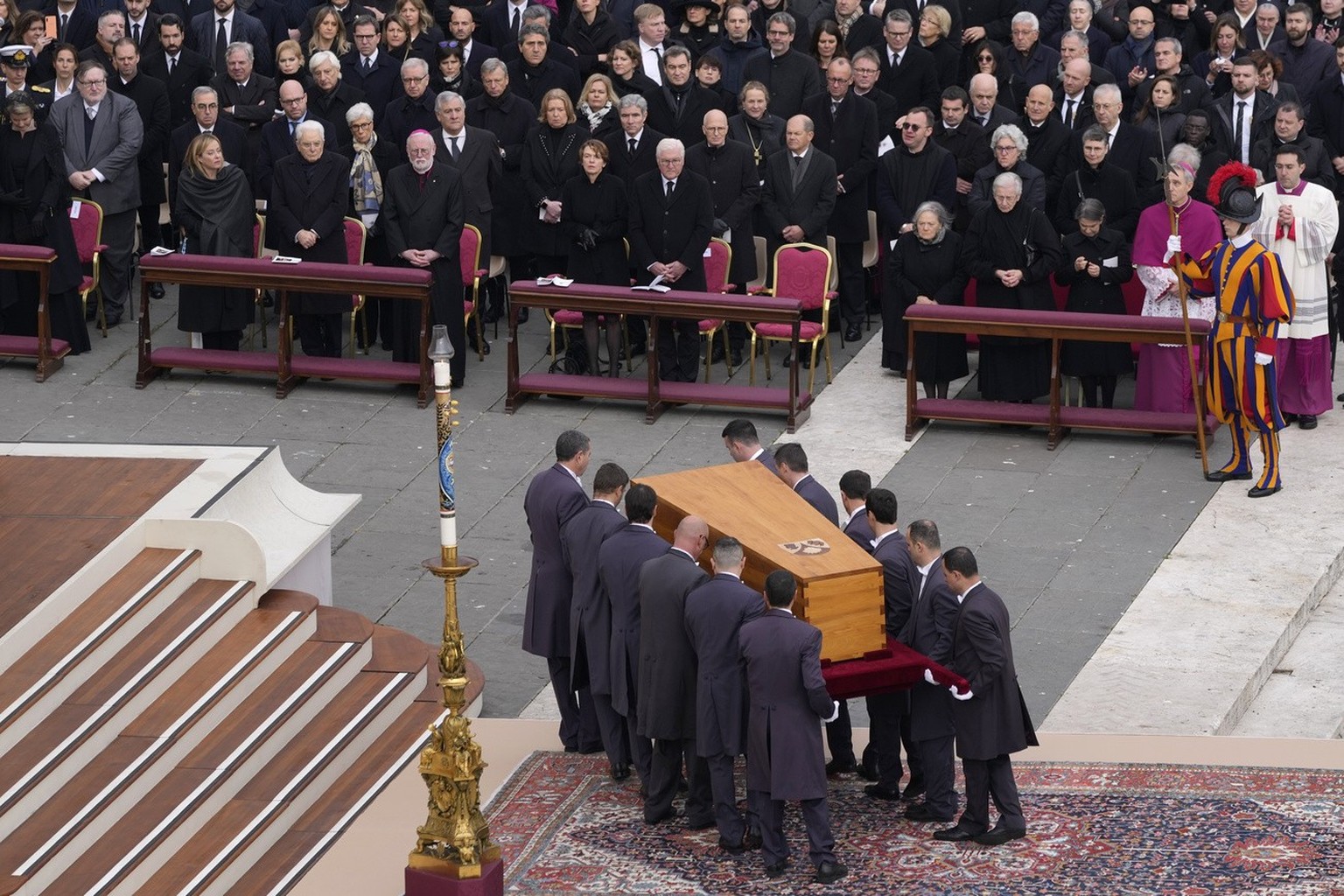 Dignitaries watch as the coffin of late Pope Emeritus Benedict XVI is carried away after a funeral mass in St. Peter&#039;s Square at the Vatican, Thursday, Jan. 5, 2023. Benedict died at 95 on Dec. 3 ...