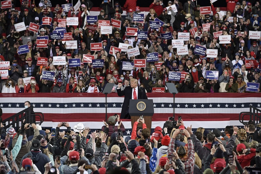 epa08865632 US President Donald J. Trump during a campaign rally to support Georgia Republican Senators David Perdue and Kelly Loeffler in their upcoming runoff election at Valdosta Regional Airport i ...