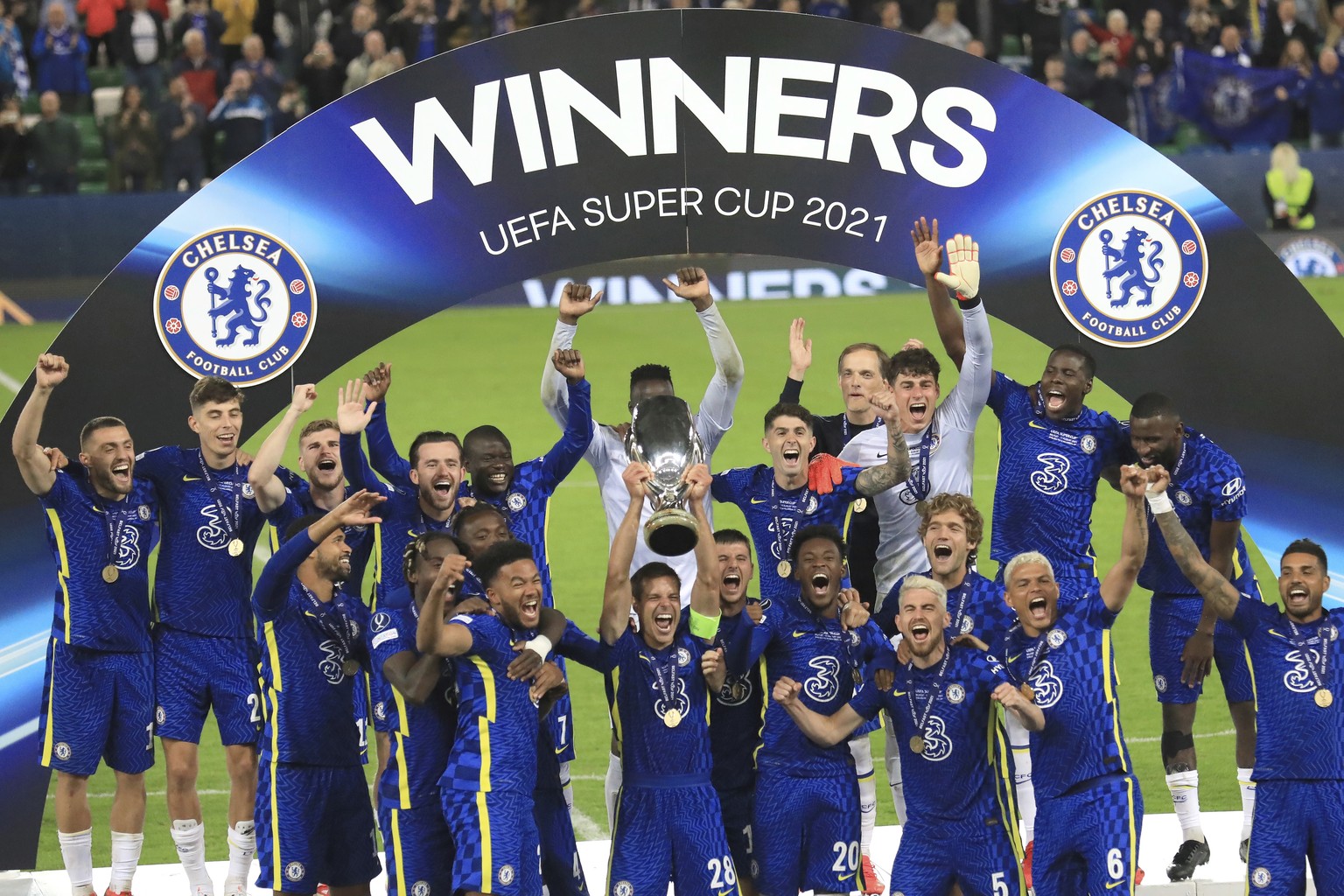 Chelsea players celebrate with the trophy after winning the UEFA Super Cup soccer match against Villarreal at Windsor Park in Belfast, Northern Ireland, Wednesday, Aug. 11, 2021. (AP Photo/Peter Morri ...