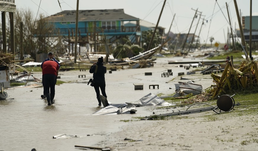 Journalists examine damage left in the wake of Hurricane Laura, Thursday, Aug. 27, 2020, in Holly Beach, La. (AP Photo/Eric Gay)