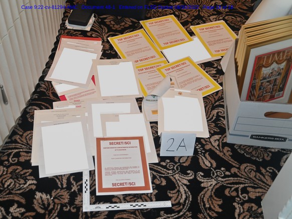 This image contained in a court filing by the Department of Justice on Aug. 30, 2022, and redacted by in part by the FBI, shows a photo of documents seized during the Aug. 8 search by the FBI of forme ...