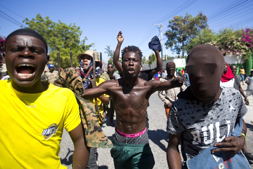 Protesters chant anti-government slogans demanding the resignation of President Jovenel Moise in Port-au-Prince, Haiti, Monday, Feb. 11, 2019. Protesters are angry about skyrocketing inflation and the ...