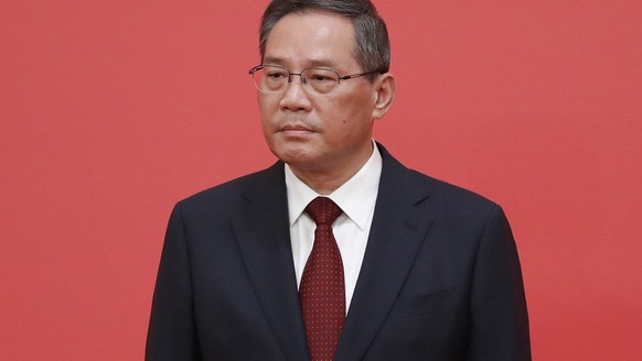 epa10260295 New member of the Standing Committee of the Political Bureau of the 20th Chinese Communist Party (CPC) Central Committee Li Qiang looks on during a press conference at the Great Hall of Pe ...