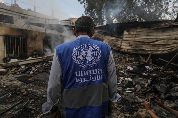 epa11339653 An UNRWA employee inspects a destroyed United Nations school following an air strike in Al Nuseirat refugee camp, central Gaza Strip, 14 May 2024. At least six people were killed in the st ...