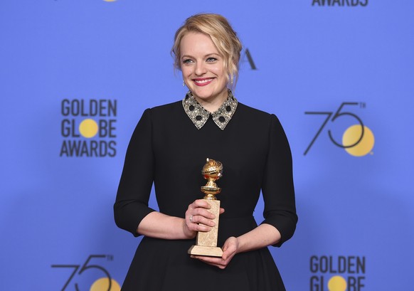 Elisabeth Moss poses in the press room with the award for best performance by an actress in a television series - drama for &quot;The Handmaid&#039;s Tale&quot; at the 75th annual Golden Globe Awards  ...