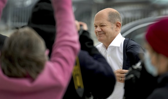Olaf Scholz of the German Social Democratic party (SPD) smiles as he arrives for coalition negotiations with representatives of the German Green party (Die Gruenen) and the German Liberals (FDP) in Be ...