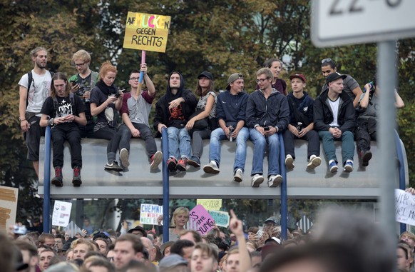 epa06995111 Concert-goers enjoy with their banners a concert in front of a stage in Chemnitz, Germany, 03 September 2018. German music groups give a free concert to support the civil society in Chemni ...