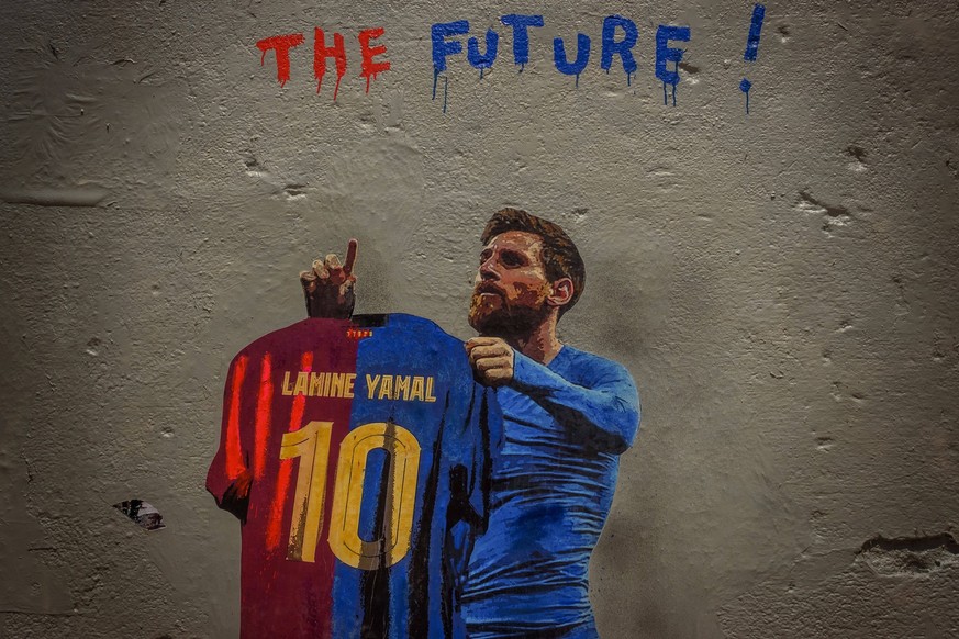 June 14, 2024, Barcelona, Catalonia, Spain: A commuter walks past a mural by Italian urban artist TVBoy , Salvatore Benintende. Titled The Future, the graffiti depicts Lionel Messi holding an FC Barce ...