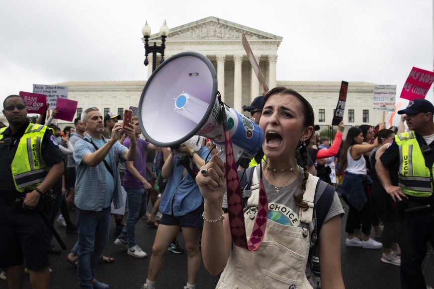 epa09947707 Abortion rights supporters march past the Supreme Court in Washington, DC, USA, 14 May 2022. Protests and rallies continue all over the US in reaction to the opinion on a leaked draft that ...