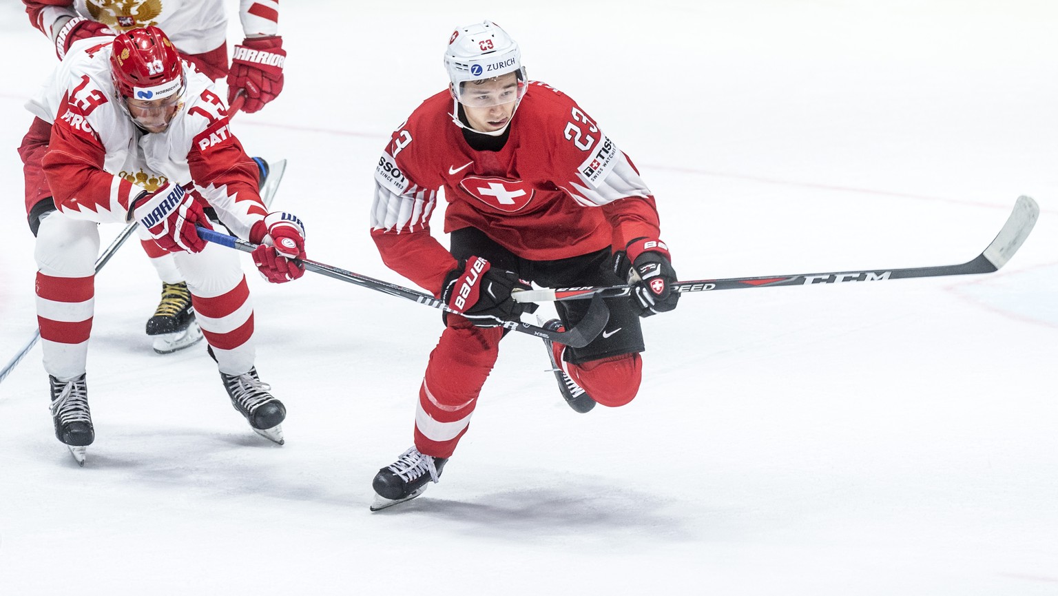 Russia`s Sergei Andronov, left, against Switzerland&#039;s Philipp Kurashev during the game between Switzerland and Russia, at the IIHF 2019 World Ice Hockey Championships, at the Ondrej Nepela Arena  ...