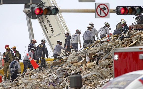 Rescue workers at the northwest corner of the site of the Champlain Towers South condo building collapse in Surfside, Fla., June 29, 2021. The building collapsed early Thursday morning trapping over a ...