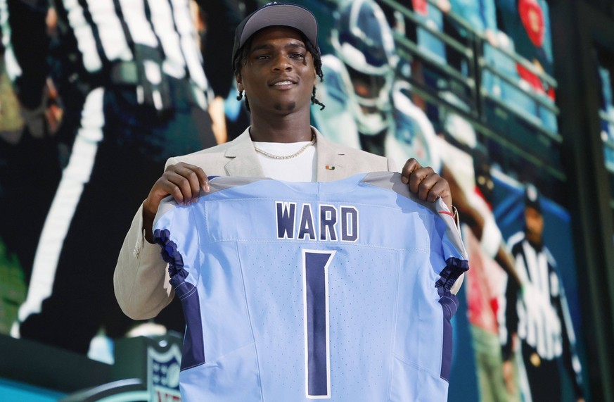University of Miami quarterback Cam Ward holds his jersey after being picked in the first round by the Tennessee Titans during the 2025 NFL, American Football Herren, USA draft at Lambeau Field in Gre ...