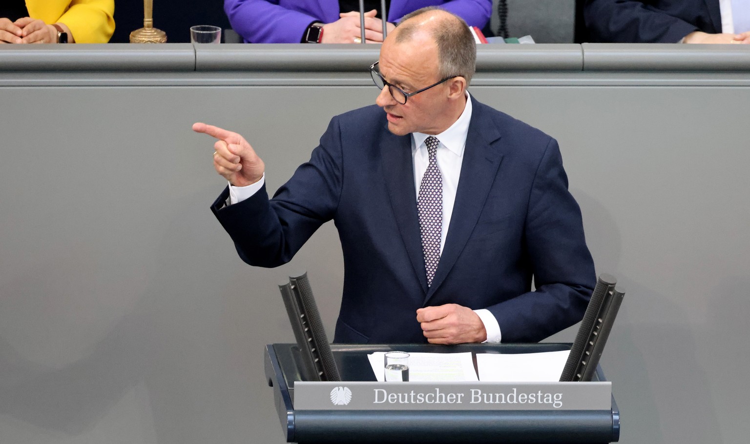 epa11971003 Christian Democratic Union (CDU) party and faction chairman Friedrich Merz gestures as he speaks during a special plenary session of the German parliament &#039;Bundestag&#039;, in Berlin, ...