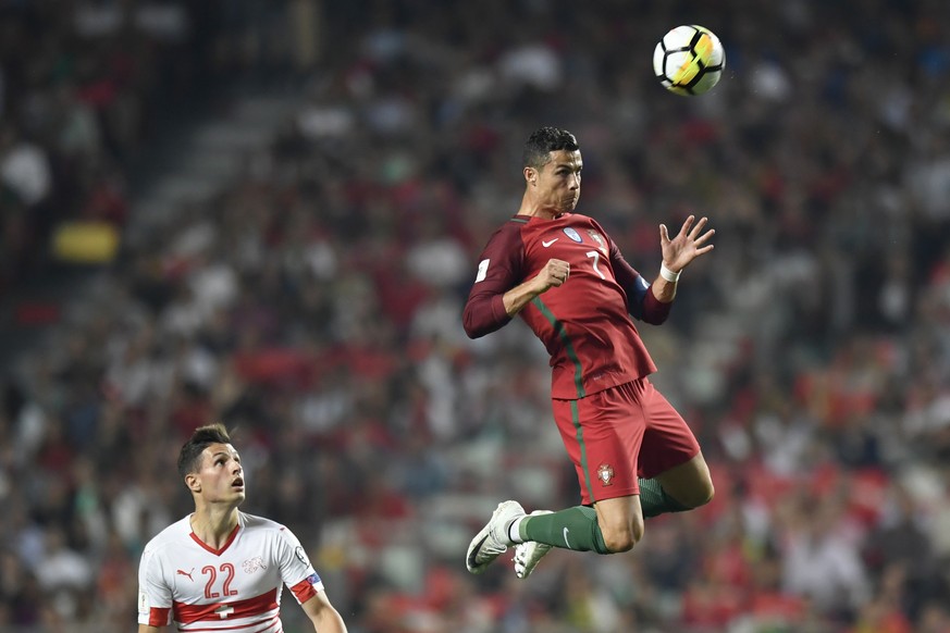 Switzerland&#039;s Fabian Schaer, left, watches Portugal&#039;s Cristiano Ronaldo, right, hitting a header during the 2018 Fifa World Cup Russia group B qualification soccer match between Portugal and ...