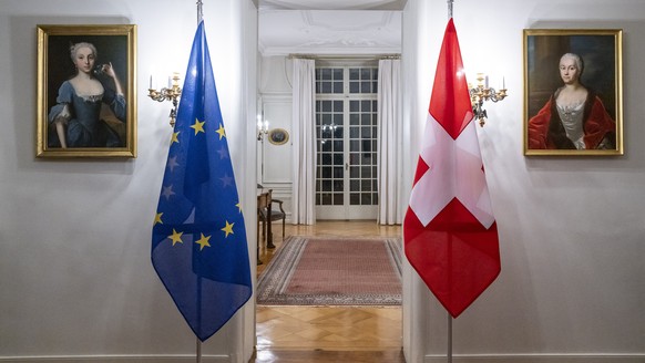 A Swiss flag, right, and an European flag stand in a room before the working visit from Maros Sefcovic, Vice-President of the European Commission by Swiss Federal Councilor Ignazio Cassis, in Bern, Sw ...