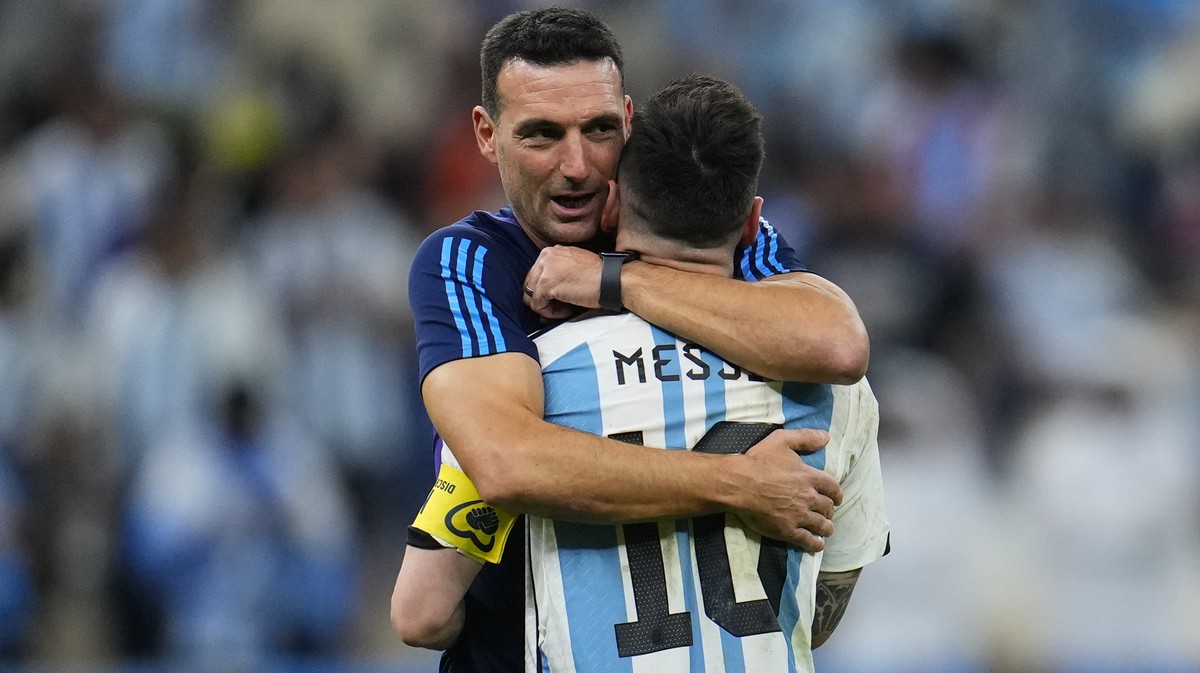 Argentina's head coach Lionel Scaloni embraces Argentina's Lionel Messi at the end of the World Cup quarterfinal soccer match between the Netherlands and Argentina, at the Lusail Stadium in  ...
