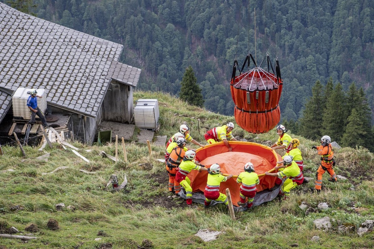 Ein Superpuma der Schweizer Armee bringt Wasser auf die Alp Gräfimatt im Kanton Obwalden (Juli 2022).