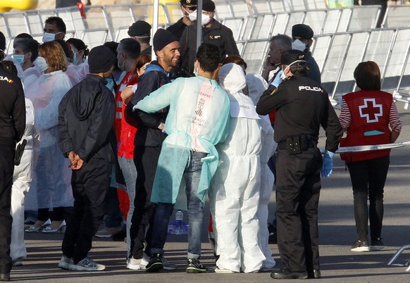 Migrants are met by emergency workers after descending the Italian coast guard vessel Dattilo upon arrival at the eastern port of Valencia, Spain, Sunday, Jun. 17, 2018. The first Italian government s ...