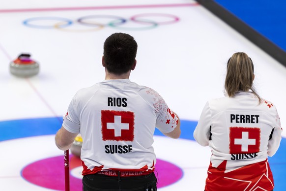 Martin Rios, left, and Jenny Perret, of Switzerland team, observe disappointed during the curling mixed doubles preliminary round game between China and Switzerland at the 2022 Olympic Winter Games in ...