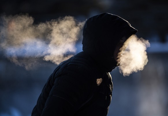 A person exhales as they make their way along the Rideau Canal Skateway in Ottawa, Ontario, on Saturday, Jan. 15, 2022. Environment Canada has issued an extreme cold warning for Ottawa with expected w ...