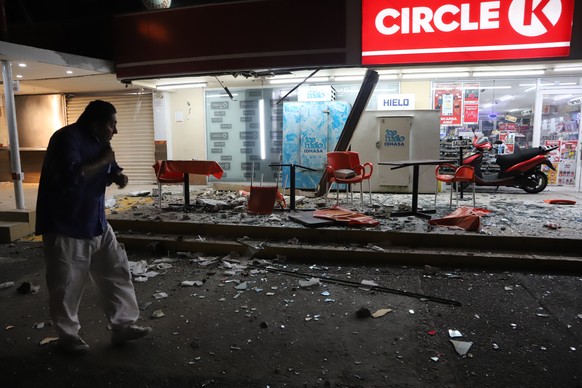 A man walks in from of a convenience store on a street covered with debris after a strong earthquake, in Acapulco, Mexico, Tuesday, Sept. 7, 2021. The quake struck southern Mexico near the resort of A ...